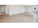 Open living area with contemporary wood-look floors offering ample space and natural light at 14400 Heritage Dr, Mead, CO 80504