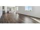 Open-concept living room leading to a kitchen with hardwood floors and natural light at 14400 Heritage Dr, Mead, CO 80504