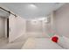 Spacious finished basement with a sliding barn door, neutral color scheme, and comfortable carpeting at 7371 Otis Ct, Arvada, CO 80003
