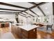 Open concept kitchen with a large island, perfect for entertaining, flowing into the dining area at 7371 Otis Ct, Arvada, CO 80003