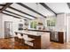 Modern kitchen with stainless steel appliances, a large center island, and beautiful hardwood floors at 7371 Otis Ct, Arvada, CO 80003