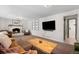 Spacious living room featuring a fireplace and mounted TV, ideal for relaxing with Gathering and friends at 7371 Otis Ct, Arvada, CO 80003