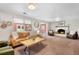 Inviting living room with cozy fireplace and view to the yard, perfect for relaxing or entertaining guests at 7371 Otis Ct, Arvada, CO 80003