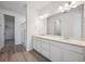 Modern bathroom with dual sinks, ample counter space, and a glass-enclosed shower at 9091 Telluride Ct, Commerce City, CO 80022