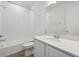 Spotless bathroom featuring white tile, modern fixtures, and a combination tub and shower at 9091 Telluride Ct, Commerce City, CO 80022