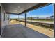 Spacious covered patio offers serene outdoor living with a view of the neighborhood at 9091 Telluride Ct, Commerce City, CO 80022