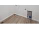 Utility space showcasing wood-look flooring, and laundry hookups, creating a functional area at 9091 Telluride Ct, Commerce City, CO 80022