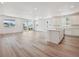 Bright, open-concept living room featuring modern flooring and large windows for ample natural light at 9091 Telluride Ct, Commerce City, CO 80022