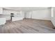 Spacious open-concept living and dining area with hardwood floors and bright, white walls at 9091 Telluride Ct, Commerce City, CO 80022