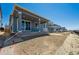 Rear view of a stylish home showing the back yard and outdoor living area with patio at 9091 Telluride Ct, Commerce City, CO 80022