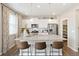 Modern kitchen with island, stainless steel appliances, and ample cabinet space at 13567 Valentia St, Thornton, CO 80602