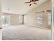 Large bedroom with high ceilings, plush carpet, and access to a private balcony at 1905 Graphite Ct, Castle Rock, CO 80108