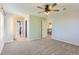 A large bedroom offers neutral walls and carpet, great light, multiple doors, and views of other floors at 1905 Graphite Ct, Castle Rock, CO 80108