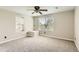 Neutral bedroom with ceiling fan, carpet, and sunny windows that allow natural light to flow through the room at 1905 Graphite Ct, Castle Rock, CO 80108