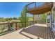 Large deck area with iron railing and shade from the upper deck overlooks a lush backyard at 1905 Graphite Ct, Castle Rock, CO 80108