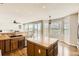 Open kitchen with island, hardwood floors, modern appliances, and views of the backyard at 1905 Graphite Ct, Castle Rock, CO 80108