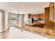 Bright kitchen features granite countertops, stainless steel appliances and wooden cabinets at 1905 Graphite Ct, Castle Rock, CO 80108