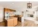 Well-appointed kitchen with granite countertops, wood cabinets, hardwood floors, and open layout at 1905 Graphite Ct, Castle Rock, CO 80108