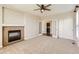 Cozy living room boasts a fireplace, neutral paint, and plush carpet at 1905 Graphite Ct, Castle Rock, CO 80108