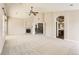 Large living room featuring fireplace, ceiling fan, and arched doorway to the kitchen and stairs at 1905 Graphite Ct, Castle Rock, CO 80108