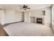 Cozy living area with tile fireplace, built-in shelving, neutral paint, and plush carpeting at 1905 Graphite Ct, Castle Rock, CO 80108