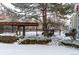 Snowy backyard with pergola and fencing at 5341 W 76Th Ave # 221, Arvada, CO 80003