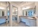 Double vanity bathroom with mirrored closet doors at 5341 W 76Th Ave # 221, Arvada, CO 80003