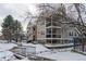 Tan two-story building with winter landscaping at 5341 W 76Th Ave # 221, Arvada, CO 80003