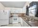 Bright kitchen with white appliances and gray cabinets at 5341 W 76Th Ave # 221, Arvada, CO 80003