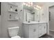 Bathroom with double vanity and floating shelves at 1126 S Yampa St, Aurora, CO 80017