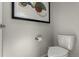 Small bathroom with toilet and wall-mounted shelving at 1126 S Yampa St, Aurora, CO 80017