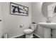 Modern bathroom with pedestal sink, toilet and gray flooring at 1126 S Yampa St, Aurora, CO 80017