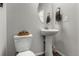 Updated bathroom with pedestal sink and toilet at 1126 S Yampa St, Aurora, CO 80017