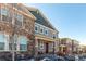 Two-story townhome with stone and siding exterior, inviting front porch, and attached garage at 1126 S Yampa St, Aurora, CO 80017