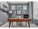 Modern home office with a large desk and plenty of natural light at 1126 S Yampa St, Aurora, CO 80017