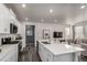 Modern kitchen with white cabinets, island with sink, and open layout at 1126 S Yampa St, Aurora, CO 80017