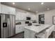 Modern kitchen with white cabinets, stainless steel appliances, and a spacious island perfect for cooking at 1126 S Yampa St, Aurora, CO 80017