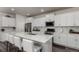Modern kitchen with white cabinets, quartz countertops and island at 1126 S Yampa St, Aurora, CO 80017