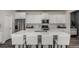 Modern kitchen featuring white cabinets, quartz countertops, and stainless steel appliances at 1126 S Yampa St, Aurora, CO 80017