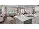 Open floor plan boasts a spacious kitchen island and modern appliances, overlooking the living room at 1126 S Yampa St, Aurora, CO 80017