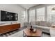 Bright living room with modern furniture, large windows, and an entertainment center with TV at 1126 S Yampa St, Aurora, CO 80017