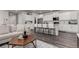 Open concept living room with wood floors, a modern coffee table, and access to the kitchen at 1126 S Yampa St, Aurora, CO 80017