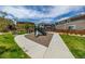 Community playground with modern play equipment, green grass, and walking paths for families to enjoy at 1126 S Yampa St, Aurora, CO 80017