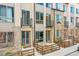 Front view of townhouses with stone accents and wooden fences at 1927 Eaton St, Lakewood, CO 80214