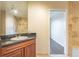 Spacious bathroom showcasing a dark vanity, sink, and an adjacent tiled bath/shower area at 975 N Lincoln St # 10A, Denver, CO 80203