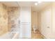 Bathroom featuring neutral colored tiling in the shower, a sink, toilet and white door at 975 N Lincoln St # 10A, Denver, CO 80203