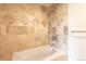 Close up on beige tile wall over a white tub and shower combination in the bathroom at 975 N Lincoln St # 10A, Denver, CO 80203