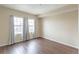 The bedroom with a window that has patterned curtains boasts wood flooring and a neutral color scheme at 975 N Lincoln St # 10A, Denver, CO 80203