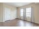 Inviting bedroom featuring two large windows and dark, wood-look laminate flooring at 975 N Lincoln St # 10A, Denver, CO 80203