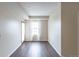 Bedroom with a window and a door leading to the outside, complemented by wood flooring and neutral walls at 975 N Lincoln St # 10A, Denver, CO 80203